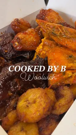 Delicious jollof rice and grilled meats at Cooked By B's, a popular African restaurant in Woolwich.