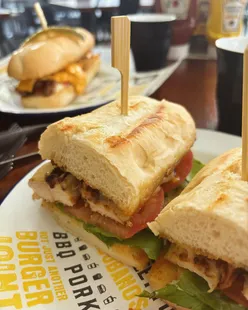 House Chicken BLT sandwich with grilled chicken, Swiss cheese, smoked bacon, lettuce, tomatoes, Reuben dressing on baguette at 5 Boroughs, Broadbeach, Australia.
