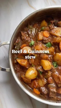 Hearty beef and Guinness stew with carrots, celery, and potatoes, perfect comfort food for cozy meals. #beefstew #comfortfoods
