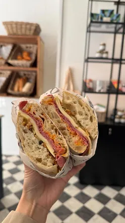 Artisan sandwiches at Loaf & Co Cheltenham: Romana with salami, roasted peppers, and New Yorker with pastrami, Swiss cheese.