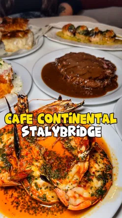 Delicious grilled dishes from Cafe Continental, showcasing fire cooking techniques and a diverse menu.