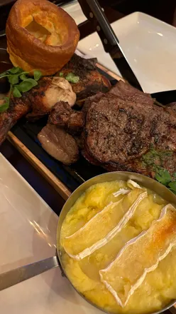 Sunday sharer board with roast chicken, lamb, ribeye steak, Camembert mash, and Yorkshire puddings at Miller and Carter Bath.