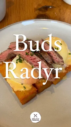 Steak Benedict on hash browns with coffee at Buds Radyr, featuring cake and patisserie selection. Dog-friendly brunch spot.