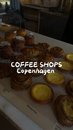 Cardamom bun and coffee at top Copenhagen cafes: Buka, Hart Bageri, Apotek 57. Must-visit spots for coffee lovers.