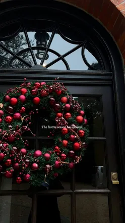 16th-century Norton Park Manor House in Hampshire, England, decorated for Christmas, surrounded by scenic countryside.