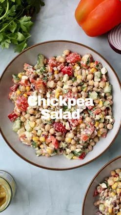 Chickpea and feta salad with beans, veggies, and honey mustard dressing in a bowl, perfect for healthy meals.