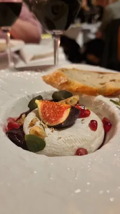 Tomini cheese baked with honey, walnuts, figs, and pomegranate, served with toasted sourdough at Tanifiki Italian Wine Dinner.