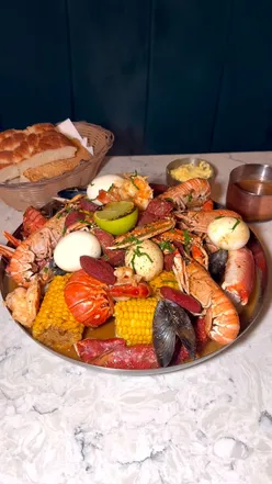 Seafood platter with lobster, crab, shrimp, and mussels at 8 Water Street Liverpool, paired with a French martini cocktail.