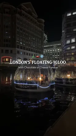 Cozy floating igloo at Canary Wharf offering fondue dining with mulled wine and scenic boat tour.