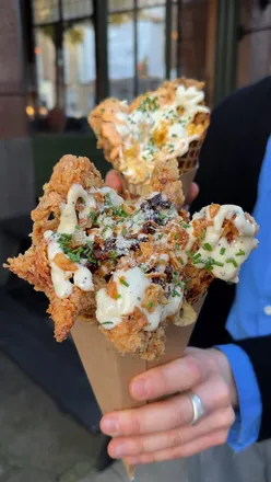 Fried chicken ice cream cones from Killa Waffle in London, featuring crispy chicken, waffle, and unique sauces.