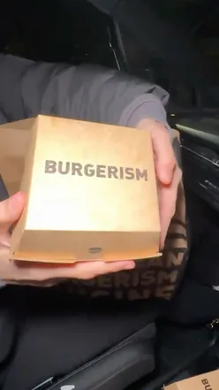 Delicious free bird burger from Burgerism in Manchester, showcasing juicy chicken and vibrant toppings.