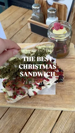 Delicious Christmas sandwich with turkey, bacon, red cabbage, and gravy, served in Brighton for the festive season.