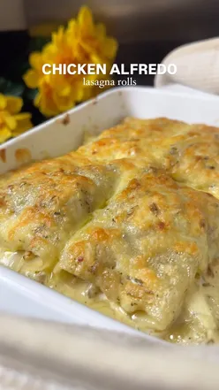 Creamy chicken Alfredo lasagna rolls topped with rich sauce and cheese, perfect for a delicious pasta meal.