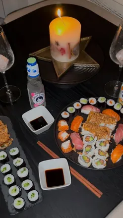 Festive Christmas tree setup with sushi platters from @sushidaily, featuring a variety of delicious rolls and nigiri.