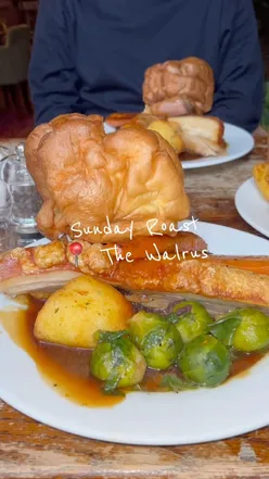 Delicious Sunday roast at The Walrus Brighton featuring tender pork, crispy crackling, and Yorkshire pudding.