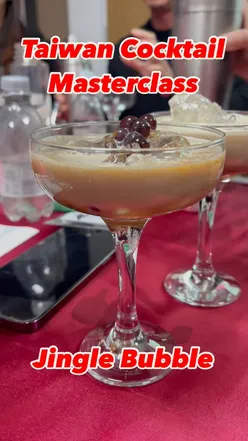 Espresso Martini inspired 'Jingle Bubble' cocktail with chocolate boba, Irish cream, and cinnamon at a Taiwanese event.