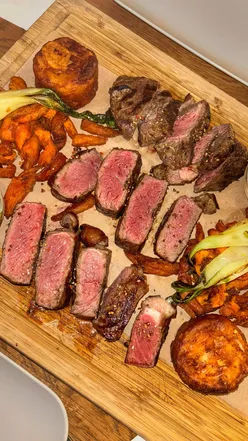 Steak platter at Beerstro14 Budapest with filet mignon, rib eye, sirloin, gratin potatoes, pak choi, sweet potato wedges.