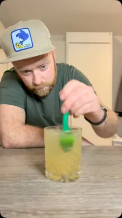 Festive whisky and ginger cocktail with lime juice, Old Jamaica ginger beer, Angostura bitters, and lime wedge garnish.