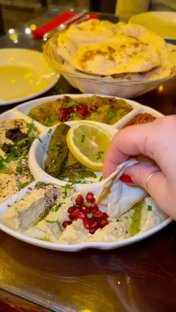 Syrian mezze platter with homemade flatbread, dips, lamb kebabs, chicken fillets, and juicy lamb chops at Bab Tooma, Oakwood.