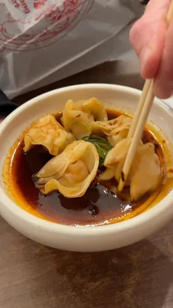 Hot pot bowl with tofu, pak choi, duck blood, and pig maw on Park Street, Bristol. Prawn dumplings on the side.