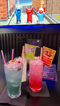 Colorful Pokémon-themed cocktails at Pixel Bar, featuring strawberry and green apple drinks, perfect for gaming sessions.