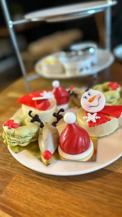 Festive afternoon tea with smoked salmon blini, scones with clotted cream, strawberry jam, and patisserie at Dreamworld Cakes.