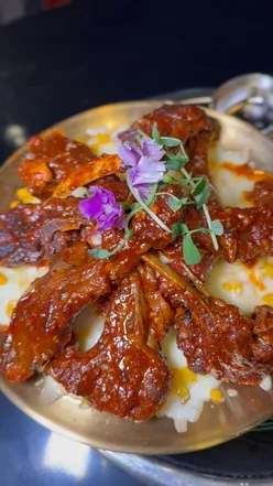 Korean lamb ribs with volcanic lava cheese pull at Itaewon Birmingham's Christmas menu, tender meat, flavorful sauce.