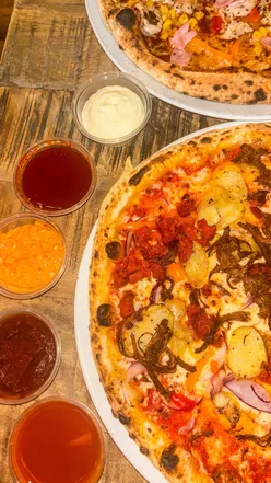 Custom pizza with chorizo, red onion, and garlic potatoes, paired with strawberry soda at Pizza Punks Nottingham.