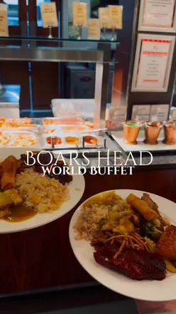 A vibrant buffet spread featuring Butter Chicken, Lamb Rogan Josh, pizza, and fresh naan at Boars Head Buffet.