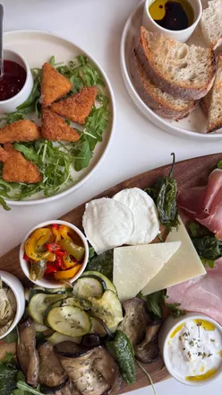 Antipasto board with fresh, crisp ingredients and creamy cheeses at Sandro's Glasgow, known for authentic Italian pizza.