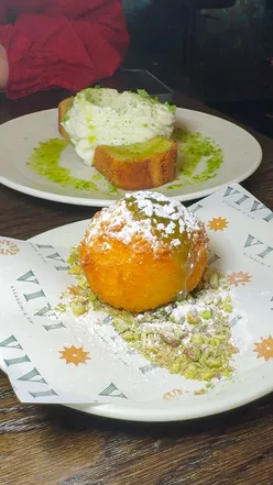 Torte Limone with vanilla ricotta and Arancino Shagliato with orange, saffron, white chocolate at Vivi Liverpool.