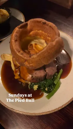 Pork and beef roast with cauliflower cheese, sweet potato chickpea curry, chips, and sticky coffee pudding at The Pied Bull.