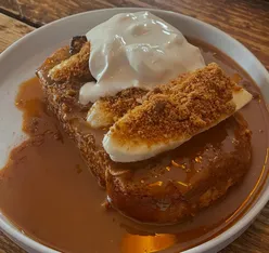 Biscoff French toast with sauce and chorizo halloumi sandwich at Station Coffee House, Prescot; cozy brunch spot.