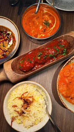 Delicious Indian dishes at Chakhdhoom: mango mocktails, poppadoms, vegetable Manchurian, and butter chicken.