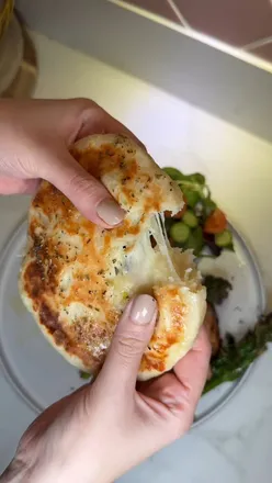 Homemade cheesy flatbreads with Korean BBQ chicken, mozzarella, salad, and pan-fried broccoli. Simple, delicious recipe.