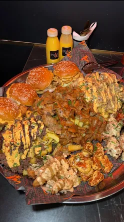 UK's largest fast food platter at Phatforlife, Bethnal Green: burgers, wings, chips, doner meat, ideal for group feasts.