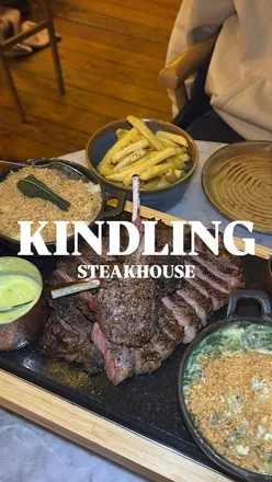 Mid-week Meat Platter at Kindling: tender sirloin, lamb cutlets, creamy cheesecake, and sides in a cozy restaurant setting.