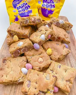 Baked cookie bars with mini eggs and chocolate chips, featuring a crispy top and gooey center, perfect for Easter treats.