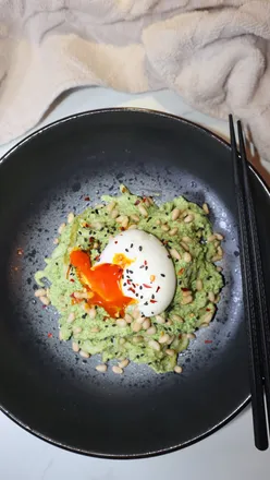 Bowl of Greens Miso and Tahini Udon Noodles topped with soft boiled egg, made using Cuisinart Easy Prep Pro Blender.