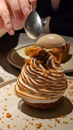 Baked Alaska dessert at Eat Drink Nord, Liverpool. Fluffy meringue, creamy ice cream, and rich cake layers.