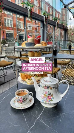 Vegan Indian afternoon tea with tea sandwiches, samosas, and sweet treats at Omnom x Namaste Village in Islington.