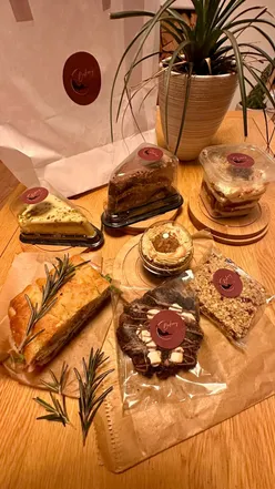 Delicious selection from Cats Bakery Bristol: focaccia, pistachio cheesecake, hazelnut cake, carrot cupcake, and more.