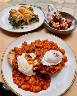 Posh beans on toast and steak sandwich brunch at North Star Coffee Shop, UK. Delicious meal with eggs and coffee.