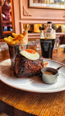 Plate of ham, egg, and chips at The Cadogan Arms, a historic Victorian pub in London, known for its elevated gastropub fare.