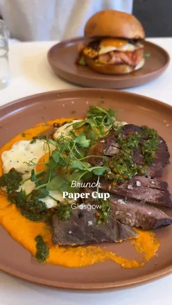 Steak and eggs with chimichurri and kimcheese brioche bun at Paper Cup cafe, Glasgow. Cozy brunch spot with amazing food.