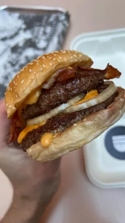 Double aged beef burger with American cheese, bacon, onion, and house sauce at Bleecker Burger, Covent Garden.