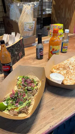 Delicious spread of pies, pierogi, tacos, and drinks enjoyed in Cardiff's vibrant food scene.