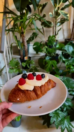 Aesthetic coffee shop in Nottingham with a croissant and coffee, perfect for foodies and cozy vibes.