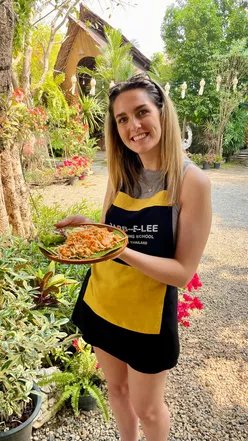 Chef teaching Thai cooking class in Chiang Mai, showcasing traditional dishes like pad thai and green curry.