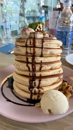 Fluffy Japanese pancakes being cut, showcasing their gorgeous texture at Pancake Cafe in Singapore.